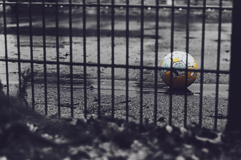 a soccer ball in a grey rainy playground