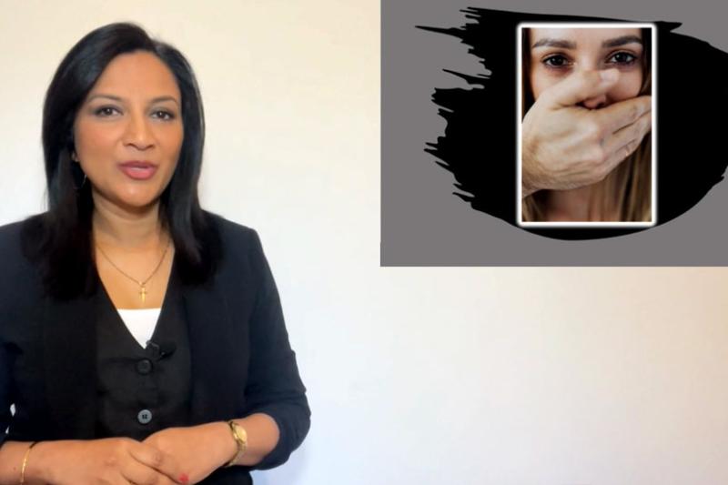 Christine D'Souza presenting her Three Minute Thesis. Christine faces the camera, to her left is a photograph of a woman who appears distressed, with a hand in front of her mouth.