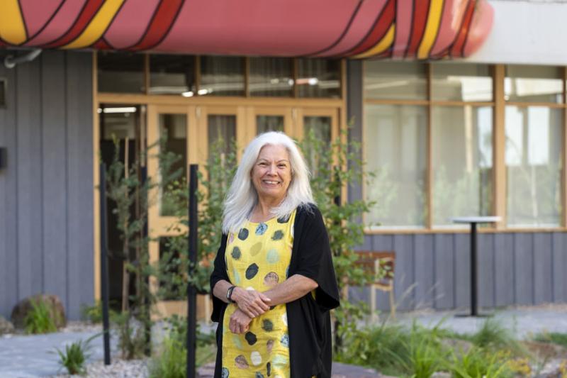 Karen Jackson (KJ) standing in the Moondani Ballluk garden. KJ is smiling at the camera.