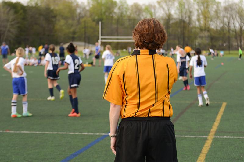 Referee at female football game.