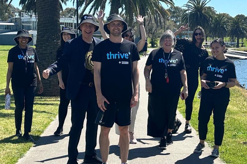 A group of thrive* participants walking by the Maribyrnong on a sunny day.