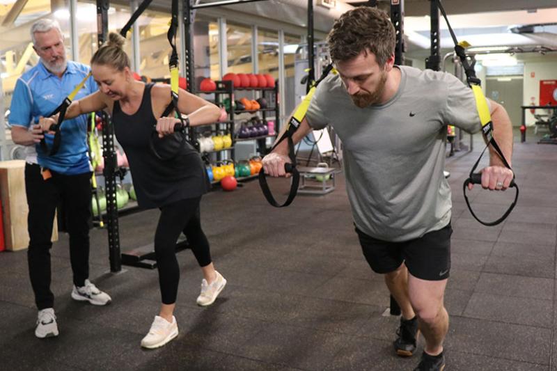 Gym goers are coached on the TRX at the Footscray Park Campus Fitness Centre.