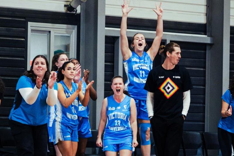University Basketball League team cheering on the sidelines