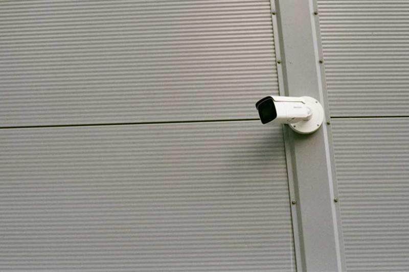 Abstract image of a surveillance camera on a wall