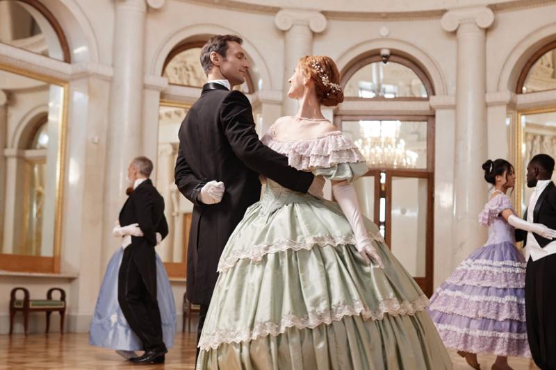 Three pairs of formally dressed people dancing in a ballroom