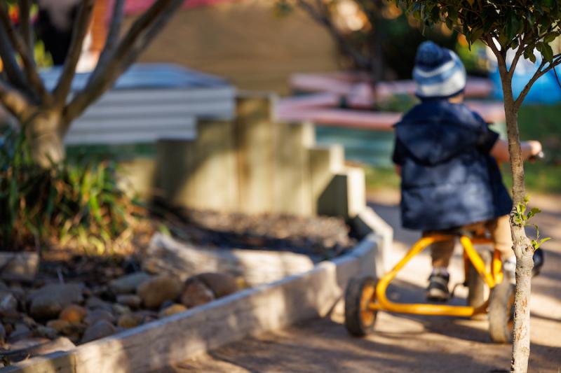 Small child riding a bike in a childcare centre