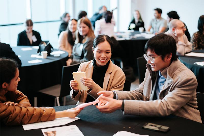 Attendees at Student Leadership Conference grouped around a table.