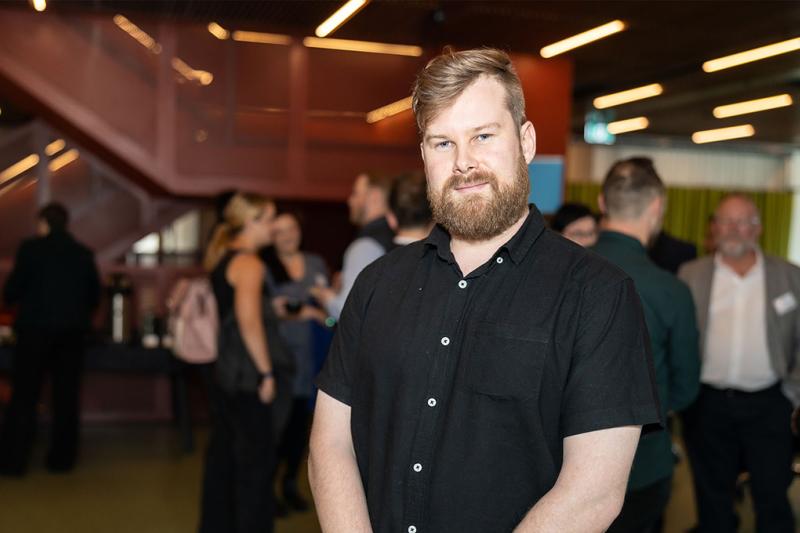 A male nursing student in a busy foyer