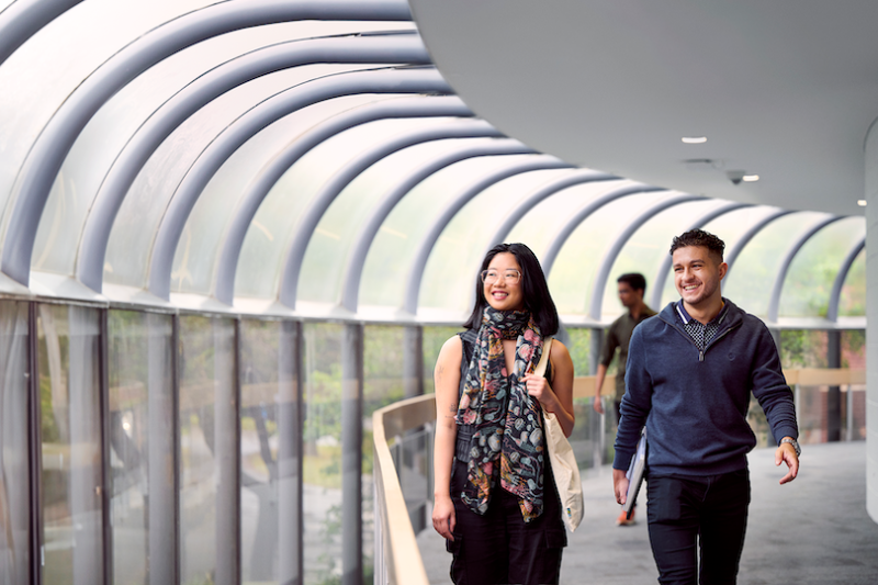Two students walking in a corridor