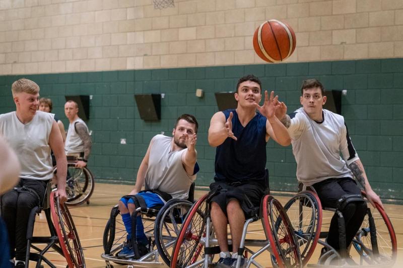 A group of people in wheelchairs playing basketball