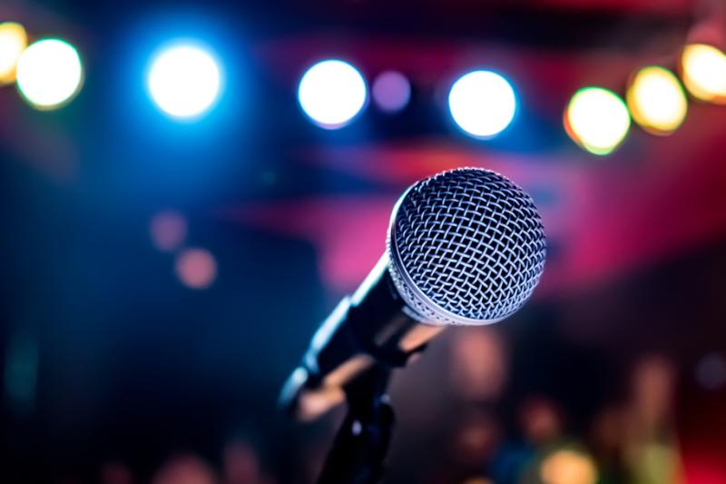 Close up of microphone with blurred background of lights. 