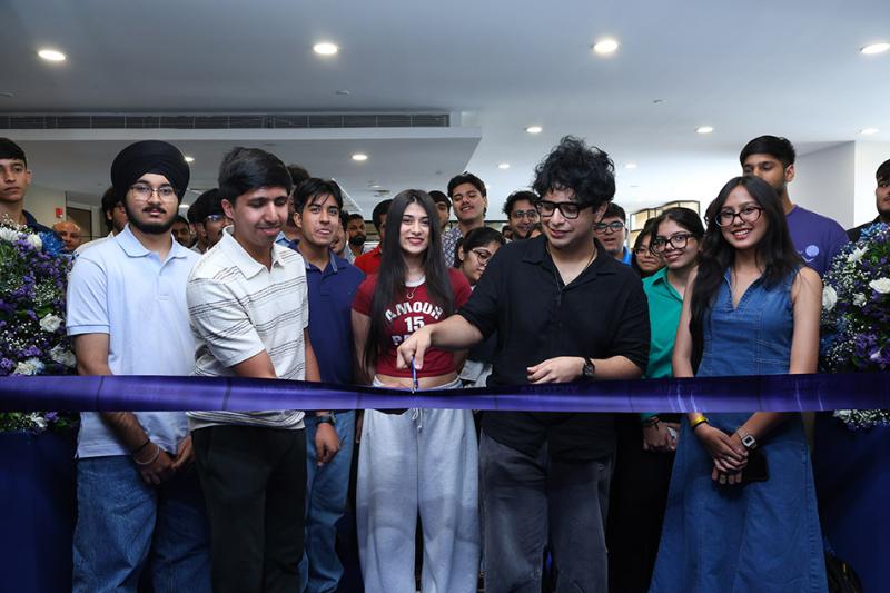 VU India students cutting a ribbon celebrating start of classes.