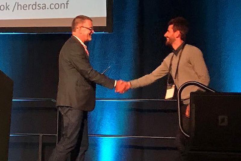  Ghaith Zakaria (R) accepts the 2018 HERSDA award