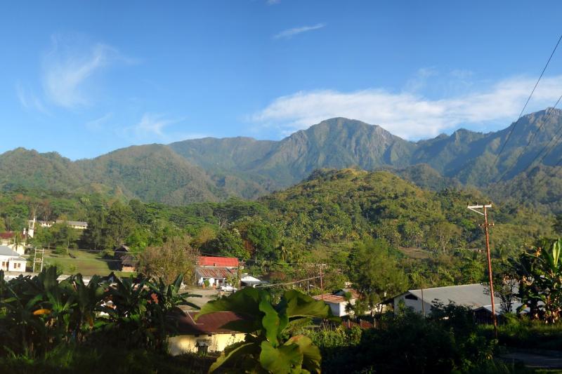  Hills, green landscape and buildings in East Timor