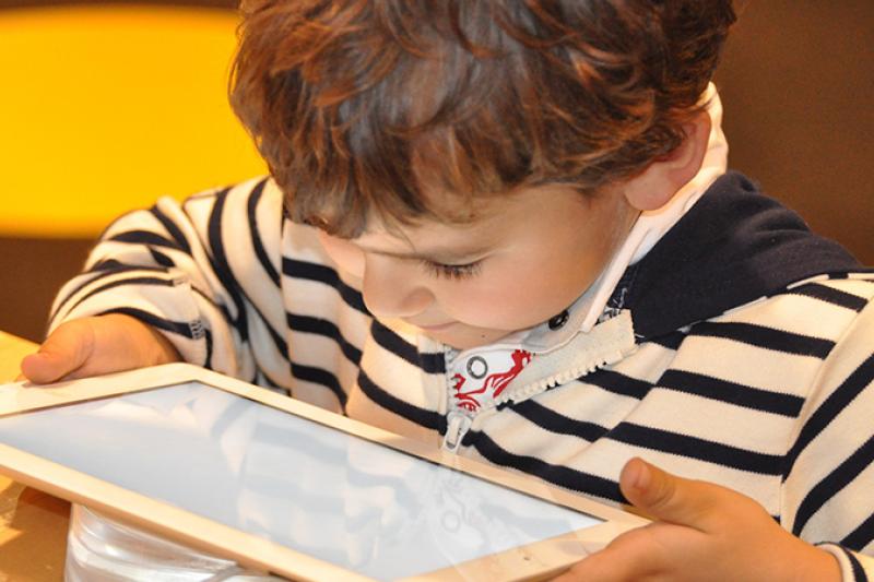  Small boy looking at an i-pad