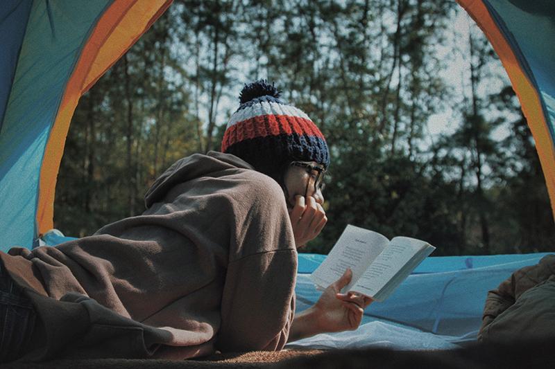  Girl camping and reading a book