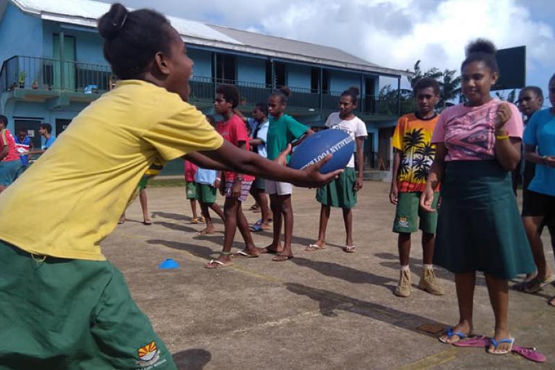  girls passing the footy in Vanuatu