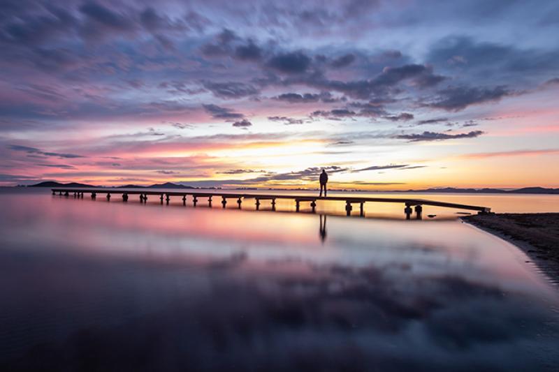  sunset, jetty, person in the distance