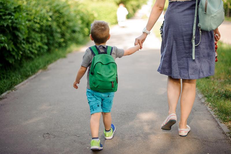  Mother walking child to preschool.