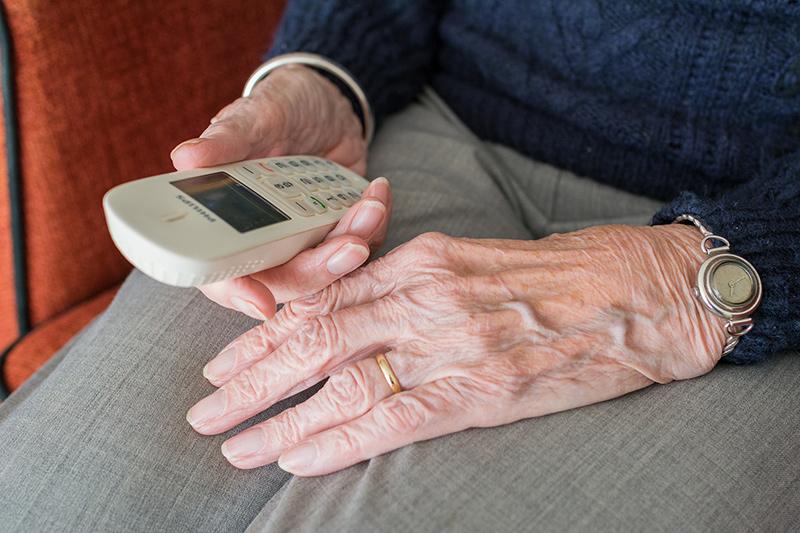elderly hands hold phone 