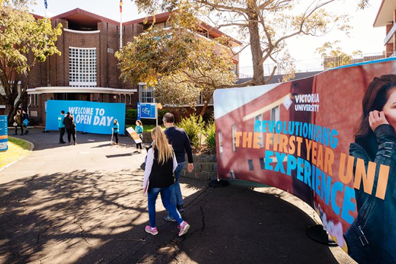 Students at Footscray Park Campus, with First Year marketing banner