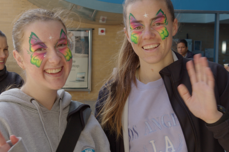  Two young women with painted faces at Open Day 2022