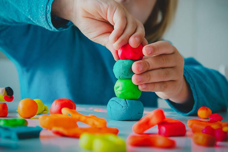  Preschool child playing with playdough