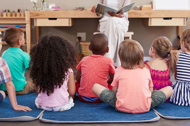 Children being read a story at preschool.