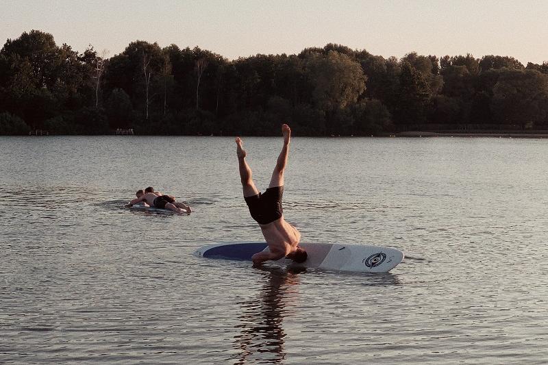 Man falling off a surfboard in Australian lake