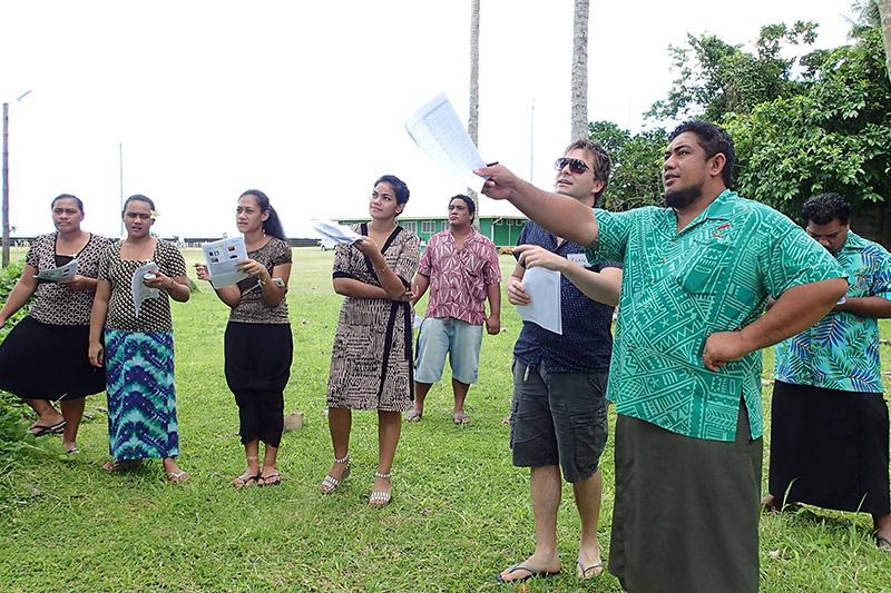 Polynesian men and women gathered on a lawn