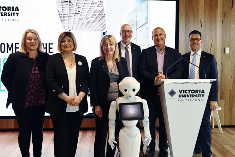 VU staff with robot at Sunshine Skills Hub opening