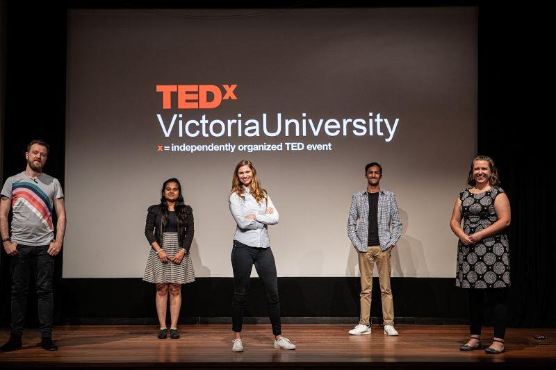 TEDX participants in front of a TEDX Victoria University screen