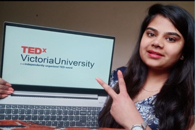 Vishwa Mehta with TEDx VictoriaUniversity on laptop screen