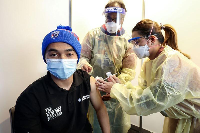 Rahmatullah Hossaini gets vaccinated at Whitten Oval's first pop-up clinic. Photo courtesy of Herald-Sun.