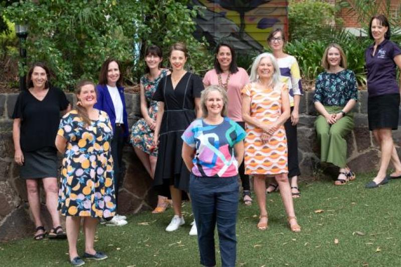  A group of people, members of VU RISE, stand together, posed and smiling. 
