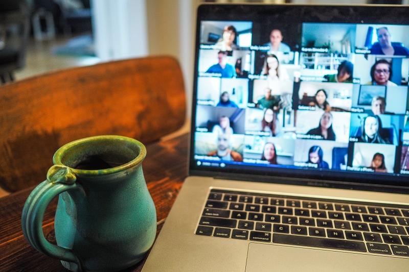 computer on desk showing Zoom meeting 