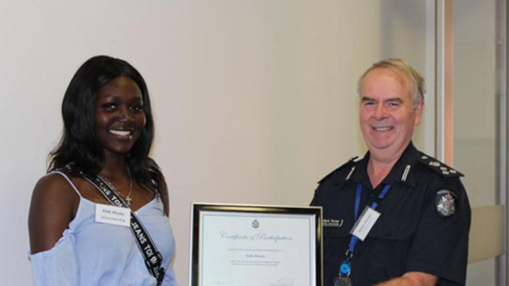 Alek, a participant of the Victoria Police Cultural Inclusion Recruitment Program, receiving her Certificate of Participation in the program from Superintendent Mark Porter.