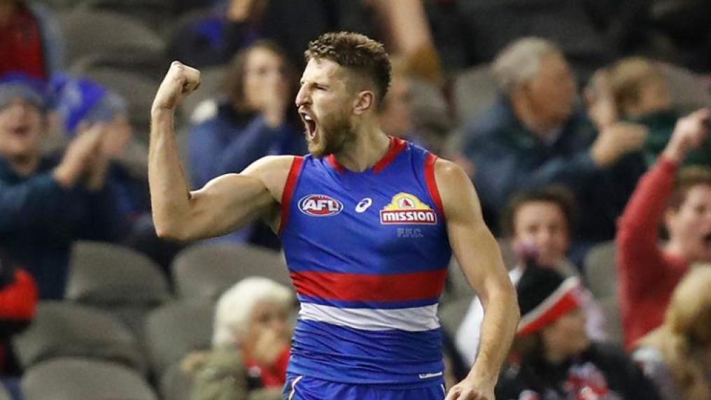 Bulldogs player raises a victory fist on the field