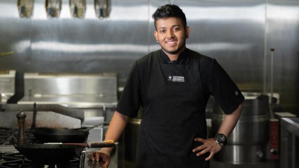 A cookery student working in the kitchen.