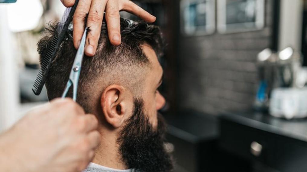 A barber cutting hair in a trendy barber shop