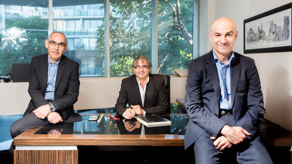 The Borzillo Brothers (L-R) Robert, Danny and Barry sitting at a desk in an office