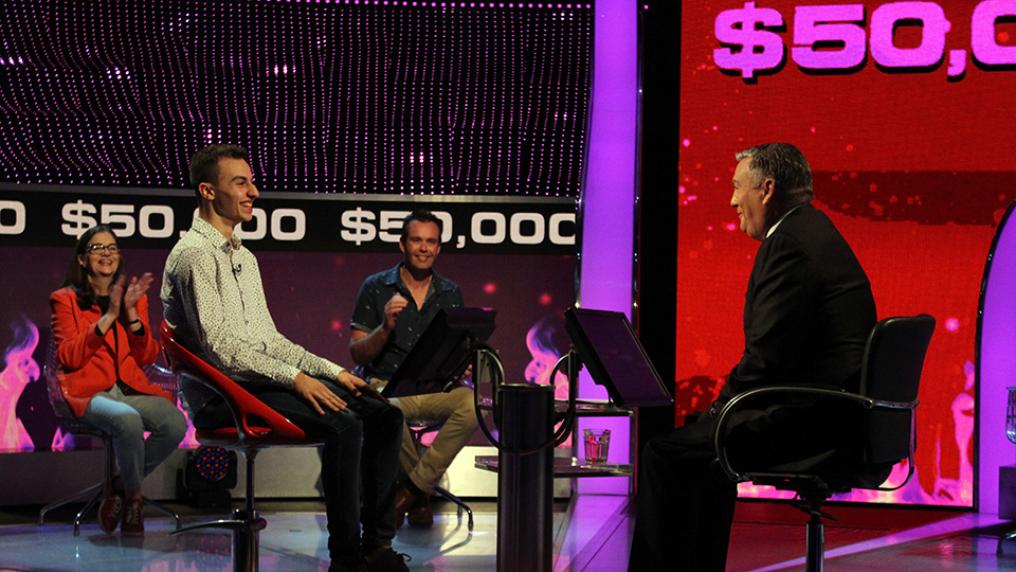 Steve Obeid smiling in a chair on the set of Channel 9 TV show Millionaire Hot Seat
