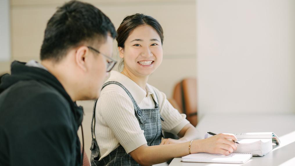 Two students sit at a desk