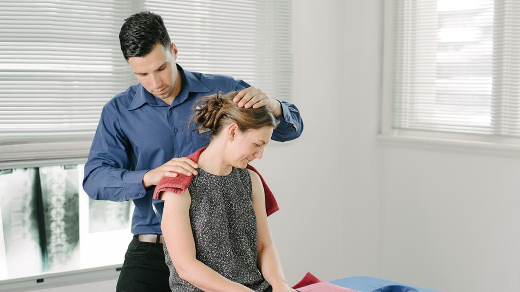 Jason Izydorczyk, osteopathy student, works with a client in the VU osteopathy clinic.