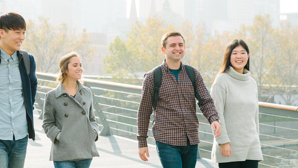VU English students walk outside and smile.