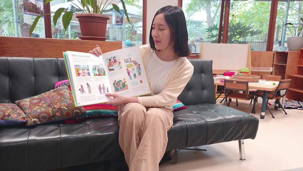 VU student Sue Lin holds a children's book.