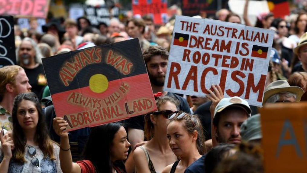 People taking part in an Invasion Day march. Photo credit: James Ross.