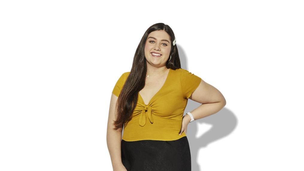 A student stands against a white background.