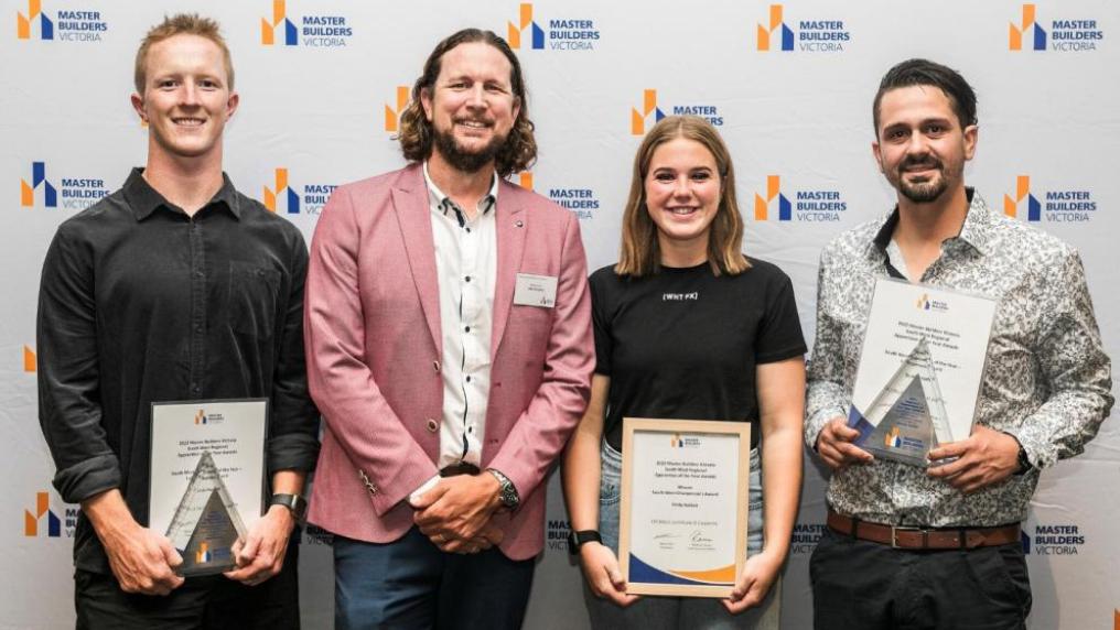 Jack and Emily posing with the presenter and third winner at the Master Builders Victoria Regional Apprentice of the Year Awards