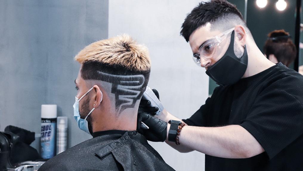 Michael Daskalakis cutting hair in salon